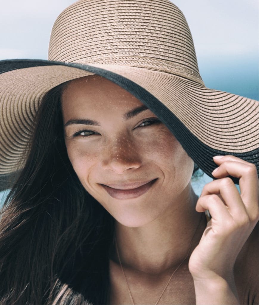 Woman wearing a sun hat at the beach